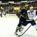 Michigan senior center Kevin Lynch checks Notre Dame sophomore defenseman Robbie Russo on Sunday, March 24. Daniel Brenner I AnnArbor.com